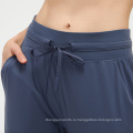 Женские леггинсы йога брюки Укороченные брюки Шкоты спортивные брюки Женщины дышащие бегущие капри с карманом